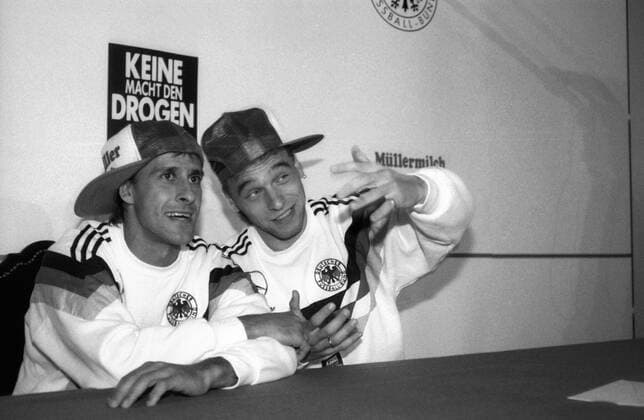 Pierre Littbarski (li.) und Thomas Häßler (beide Deutschland) ahmen am Rande der WM 1990 die Fernsehsendung Dingsda nach - DEUTSCHSPRACHIGE SPORTZEITSCHRIFTEN UND -ZEITUNGEN NUR NACH RÜCKSPRACHE Fußball WM Herren WM 1990, BR Deutschland, BRD, DFB, Aufnahmedatum geschätzt Gruppe