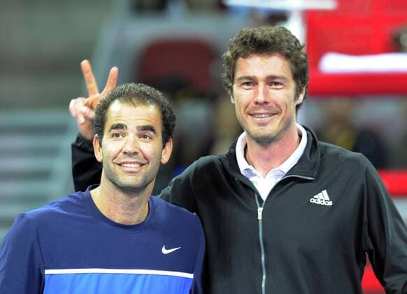 Russia s Marat Safin (R) and Pete Sampras of the United States pose before the debut match at the new stadium of China Open 2011, Sept. 30, 2011. (Xinhua Li Wen) CHINA-BEIJING-TENNIS-CHINA OPEN (CN) 