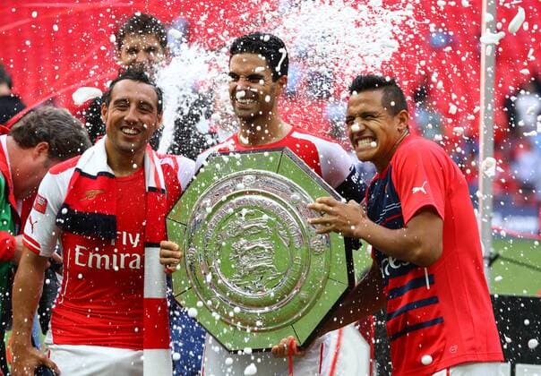 FA Community Shield - Arsenal v Manchester City . . Wembley, Middlesex, UK . . 10.08.2014 Santi Cazorla (A), Mikel Arteta (A) and Alexis Sanchez (A) celebrate with the FA Community Shield.