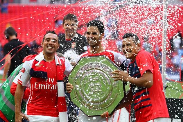 FA Community Shield - Arsenal v Manchester City . . Wembley, Middlesex, UK . . 10.08.2014 Santi Cazorla (A), Mikel Arteta (A) and Alexis Sanchez (A) celebrate with the FA Community Shield.