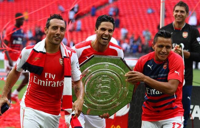 FA Community Shield - Arsenal v Manchester City . . Wembley, Middlesex, UK . . 10.08.2014 Santi Cazorla (A), Mikel Arteta (A) and Alexis Sanchez (A) celebrate with the FA Community Shield.