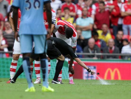 FA Community Shield - Arsenal v Manchester City . . Wembley, . 10.08.2014 Referee Michael Oliver uses his vanishing spray to mark out where the wall should stand.