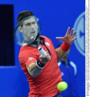 (151008) -- BEIJING, Oct. 8, 2015 -- Novak Djokovic of Serbia hits a return to Zhang Ze of China during their men s singles second round match at the China Open tennis tournament in Beijing, China, Oct. 8, 2015. Djokovic was qualified for the next round after beating Zhang 2-0. ) (SP)CHINA-BEIJING-TENNIS-CHINA OPEN-MEN S SINGLES-DJOKOVIC LixWen