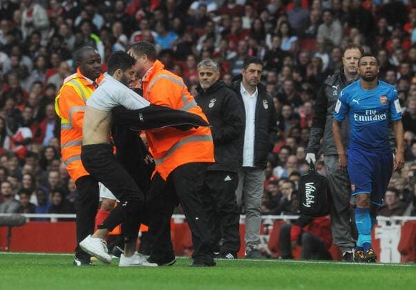 Football - 2017 Emirates Cup pre-season friendly competition - Arsenal vs. Benfica A fan is restrained by staff after running onto the pitch at The Emirates. COLORSPORT ANDREW COWIE