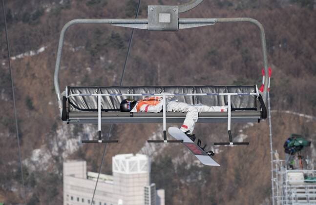 A snowboarder feature snowboard slopestyle training Phoenix snowpark is exhausted exhausted in a chair lift in General on 08 02 2018 Winter Olympics 2018 from 09 02 25 02 2018 in PyeongChang of South Korea