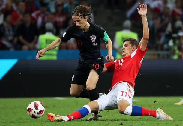 SOCHI, RUSSIA - JULY 7, 2018: Croatia s Luka Modric (L) and Russia s Roman Zobnin fight for the ball in their 2018 FIFA World Cup WM Weltmeisterschaft Fussball Quarterfinal match at Fisht Stadium. Croatia won the game on penalties 4-3. Alexander Demianchuk TASS  TS08893C