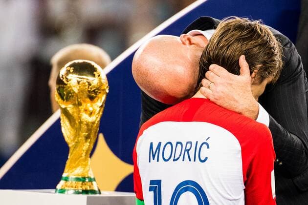 180715 Luka Modric of Croatia walks by the trophy and gets a hug by FIFA President Gianni Infantino during the medal ceremony after the FIFA World Cup final match between France and Croatia on July 15, 2018 in Moscow Photo Petter Arvidson BILDBYR N Code PA 92087  Copyright: PETTERxARVIDSON BB180715PA424