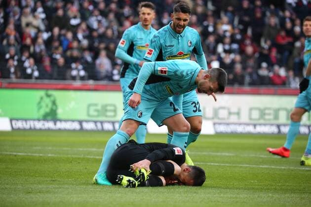 Jerome Gondorf SC Freiburg and Vincenzo Grifo SC Freiburg scream at the grounded Filip Kostic Frankfurt because they suspect a spectacle at the match Eintracht Frankfurt vs. SC Freiburg in the 1 Soccer Bundesliga on 19 01 2019 DFL REGULATIONS PROHIBIT ANY USE OF PHOTOGRAPHS AS IMAGE SEQUENCES AND OR QUASI VIDEO Eintracht Frankfurt vs SC Freiburg Soccer 1 Bundesliga 19 01 2019 Frankfurt Copyright: xEIBNER MichaelxBermelx EP_MBL