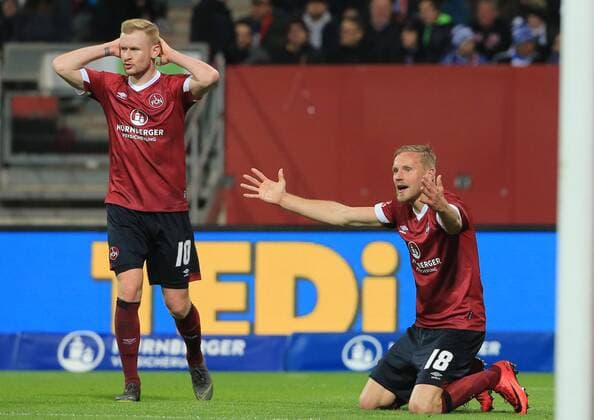 12 04 2019 1 Bundesliga 1 FC Nuernberg vs Schalke 04 Max Morlock Stadium Soccer Sports in picture Sebastian Kerk 1 FC Nuernberg and Hanno Behrens 1 FC Nuernberg after invalid goal DFL REGULATIONS PROHIBIT ANY USE OF PHOTOGRAPHS AS IMAGE SEQUENCES AND OR QUASI VIDEO