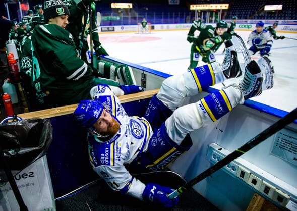 210225 Leksands Mattias Ritola is tackled and slides into the photographers base during the ice hockey match in the SHL between Färjestad and Leksand on 25 February 2021 in Karlstad,  Copyright: FREDRIKxKARLSSON BB210225FK042