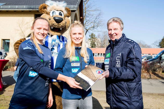 03 03 2021, Soccer, 1 Frauenbundesliga, Turbine Potsdam celebrates 50th anniversary with champagne reception and cake, Luftschiffhafen Potsdam in picture from l Karoline Smidt Nielsen 1 FFC Turbine Potsdam ,Merle Barth Turbine Potsdam ,President Rolf Kutzmutz Turbine Potsdam handing over the club chronicle Potsdam