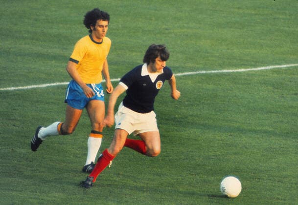 Football - 1974 World Cup - First Round, Group Two: Scotland 0 Brazil 0 Scotland s Peter Lorimer, with Brazil s Nelinho, left, at the Waldstadion, Frankfurt. 18 06 1974