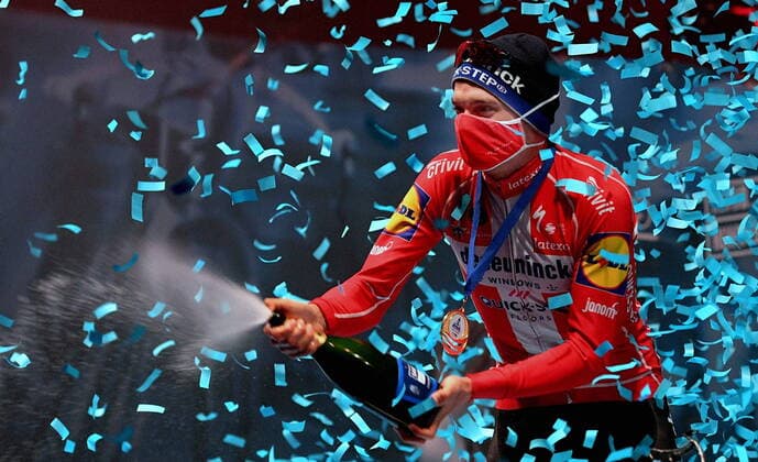 Winner Danish Kasper Asgreen of Deceuninck Quick Step celebrates on the podium with champagne after the E3 Saxo Bank Classic cycling race, 203, 9km from and to Harelbeke, Friday 26 March 2021 BELGA PHOTO DAVID STOCKMAN, HARELBEKE Denmark  Copyright: DAVIDxSTOCKMANx cop102 spdk20210326-175841-L
