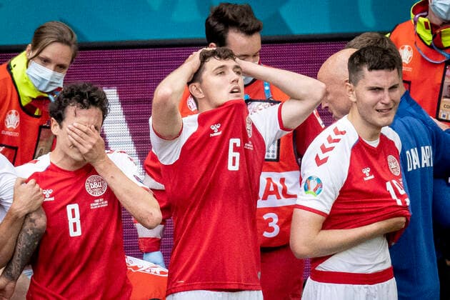 Denmarks Thomas Delaney, Denmarks Andreas Christensen and Denmarks Jonas Wind while Denmarks Christian Eriksen receives treatment during the match between Denmark and Finland in group B during EURO2020 in the Park in Copenhagen, Saturday 12 June 2021, Copenhagen Denmark  Copyright: RitzauxScanpix MadsxClausxRasmussenx cop101 spdk20210612-201243-L