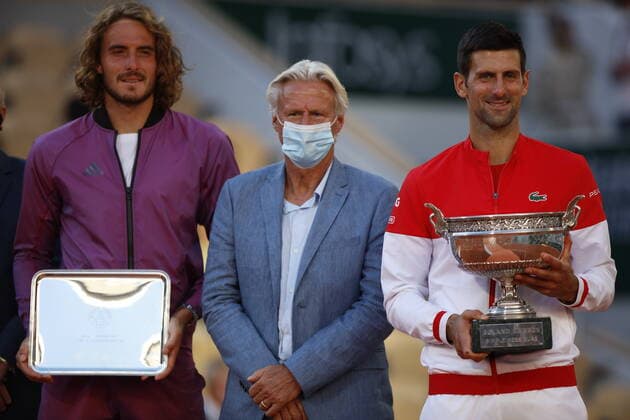 Final Men - French Open Novak Djokovic of Serbia embraces former tennis player Bjorn Borg as receives the trophy after winning his Men s Singles Final match against Stefanos Tsitsipas of Greece who looks dejected in the background during Day Fifteen of the 2021 French Open at Roland Garros on June 13, 2021 in Paris, France. Paris France taamallah-notitle210613_npd7Y  Copyright: xMehdixTaamallahx