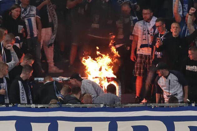 Fans of 1 FC Magdeburg burn fan paraphernalia of 1 FC Kaiserslautern in the fan block 3 Liga football season 2021 2022 Punktspiel 1 FC Magdeburg vs 1 FC Kaiserslautern at the MDCC Arena in Magdeburg Football,Man,Men,Germany,04 09 2021