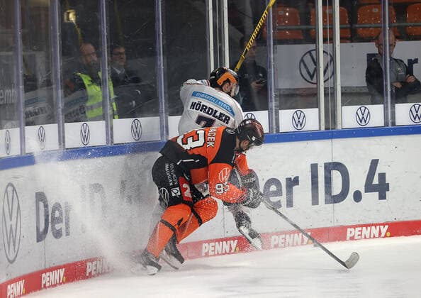 Spencer Machacek Grizzlys Wolfsburg in duel with Frank Hoerdler EHC Eisbaeren Berlin