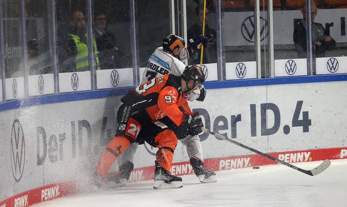 Spencer Machacek Grizzlys Wolfsburg in duel with Frank Hoerdler EHC Eisbaeren Berlin