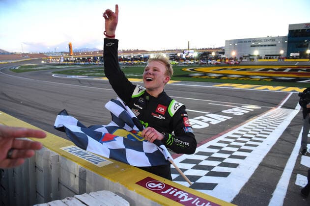 LAS VEGAS, NV - MARCH 05: Ty Gibbs ( 54 Joe Gibbs Racing Monster Energy Toyota) receives the Sunoco checkered flag as he celebrates winning the race during the NASCAR, Motorsport, USA Xfinity Series Alsco Uniforms 300 on March 05, 2022, at Las Vegas Motor Speedway in Las Vegas, NV. (Photo by Chris Williams Icon Sportswire) AUTO: MAR 05 NASCAR Xfinity Series - Alsco Uniforms 300 Icon0072203051196
