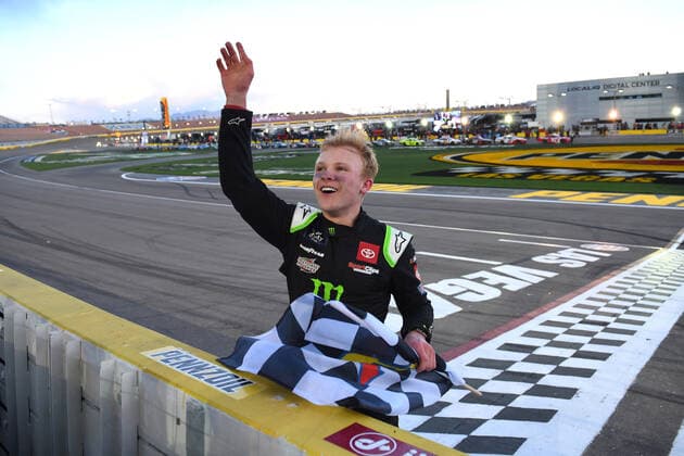 LAS VEGAS, NV - MARCH 05: Ty Gibbs ( 54 Joe Gibbs Racing Monster Energy Toyota) receives the Sunoco checkered flag as he celebrates winning the race during the NASCAR, Motorsport, USA Xfinity Series Alsco Uniforms 300 on March 05, 2022, at Las Vegas Motor Speedway in Las Vegas, NV. (Photo by Chris Williams Icon Sportswire) AUTO: MAR 05 NASCAR Xfinity Series - Alsco Uniforms 300 Icon0072203051198