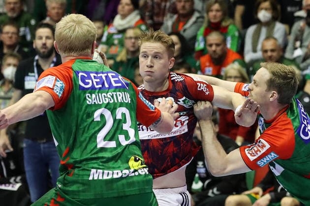 Jonathan Edvardsson TSV Hannover Burgdorf,26 vs Magnus Saugstrup SC Magdeburg,23 and Omar Ingi Magnusson SC Magdeburg,14 Handball Bundesliga season 2021 2022 SC Magdeburg vs TSV Hannover Burgdorf at GETEC Arena in Magdeburg Action,man,men,handball,Germany,31 03 2022