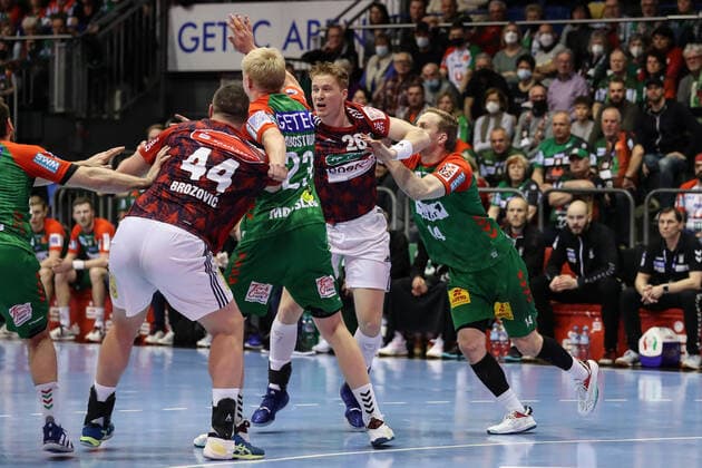 Jonathan Edvardsson TSV Hannover Burgdorf,26 and Ilija Brozovic TSV Hannover Burgdorf,44 against Magnus Saugstrup SC Magdeburg,23 and Omar Ingi Magnusson SC Magdeburg,14 Handball Bundesliga Season 2021 2022 SC Magdeburg vs TSV Hannover Burgdorf at GETEC Arena in Magdeburg Action,man,men,handball,Germany,31 03 2022