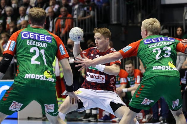 Jonathan Edvardsson TSV Hannover Burgdorf,26 vs Magnus Gullerud SC Magdeburg,21 and Magnus Saugstrup SC Magdeburg,23 Handball Bundesliga season 2021 2022 SC Magdeburg vs TSV Hannover Burgdorf at GETEC Arena in Magdeburg Action,man,men,handball,Germany,31 03 2022