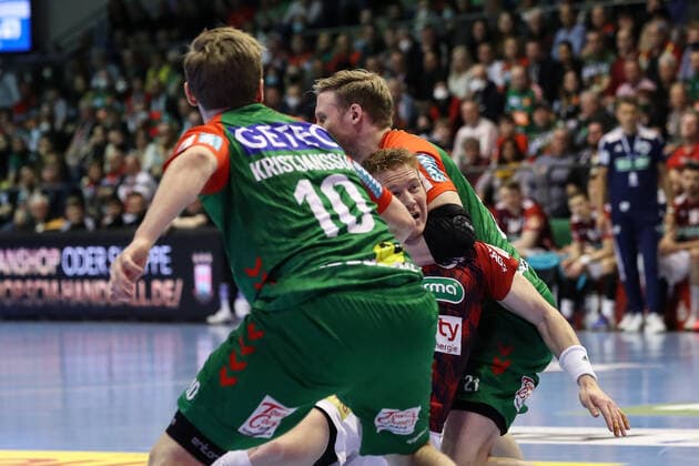 Jonathan Edvardsson TSV Hannover Burgdorf,26 vs Magnus Gullerud SC Magdeburg,21 and Gisli Kristjansson SC Magdeburg,10 Handball Bundesliga season 2021 2022 SC Magdeburg vs TSV Hannover Burgdorf in the GETEC Arena in Magdeburg Action,man,men,handball,Germany,31 03 2022