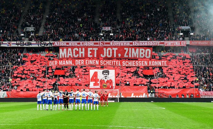 Football, 2 Bundesliga, Germany, Men, Season 2021 2022, 29 Matchday, Merkur Spiel Arena Düsseldorf, Fortuna Düsseldorf red FC Hansa Rostock white minute of silence and choreography for the late Gerd Zimbo Zimmermann DFB DFL REGULATES PROHIBIT ANY USE OF PHOTOGRAPHS AS IMAGE SEQUENCES AND OR QUASI VIDEO