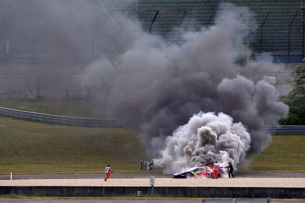 burning Ferrari 488 GT3 Nr 74, driver Felipe Fraga BRA right side trying to extinguish with fire extinguisher, DTM Qualifiyng, Lausitzring, Eurospeedway, 22 05 2022, fire