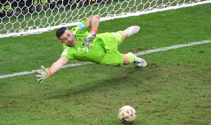 Football World Cup, Men, Qatar 2022, Final, Lusail Iconic Stadium, Argentina France 4 2 n E Emiliano Martinez ARG taking penalty from Aurelien Tchouameni FRA , shooting past goal FIFA REGULATES PROHIBIT ANY USE OF PHOTOGRAPHS AS IMAGE SEQUENCES AND OR QUASI VIDEO