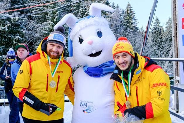 Eberspächer Luge World Cup in Altenberg on 04 02 2023 Award ceremony mens doubles Toni Eggert and Sascha Benecken GER with Flocki