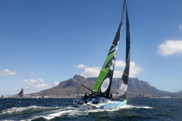 IMOCA from Team Holcim PRB SUI Skipper Kevin Escoffier FRA in front of Table Mountain between mark 1 2 during the Port race, Port race, The Ocean Race VO65, 3 leg Cape Town RSA Itajai BRA 24 02 2023, Cape Town, South Africa, RSA