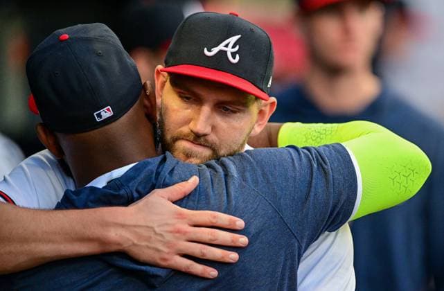 Atlanta Braves starting pitcher Dylan Lee (52) is greeted in the dugout after a pitching change against the Boston Red Sox during the third inning of a Major League Baseball game at Truist Park in Atlanta, Georgia, on Wednesday, May 10, 2023. ATL20230510108 DAVIDxTULIS