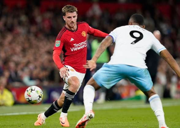 MANCHESTER, ENGLAND, 26th September 2023. Mason Mount of Manchester United, ManU pops the ball past Jordan Ayew of Crystal Palace during the Carabao Cup match at OLD TRAFFORD, MANCHESTER. Picture credit should read: Andrew Yates Sportimage EDITORIAL USE ONLY. No use with unauthorised audio, video, data, fixture lists, club league logos or live services. Online in-match use limited to 120 images, no video emulation. No use in betting, games or single club league player publications. SPI-2605-0050