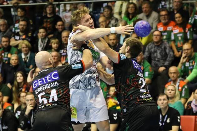 Jonathan Edvardsson TSV Hannover Burgdorf,26 vs Albin Lagergren SC Magdeburg,21 and Oscar Bergendahl SC Magdeburg,54 Handball Bundesliga Season 2023 2024 SC Magdeburg vs TSV Hannover Burgdorf at GETEC Arena in Magdeburg Action,Handball,Germany,15 10 2023