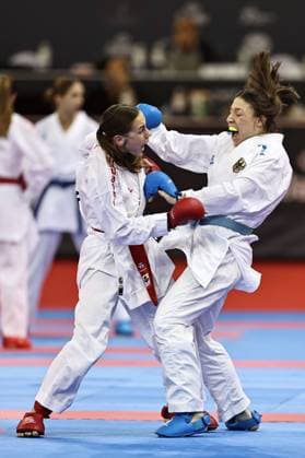 Madeleine Schröter, GER blue , and an Ukrainian player unknown due to unprofessional organization during female s team kumite at 2023 karate world championships in Budapest 26 10 2023