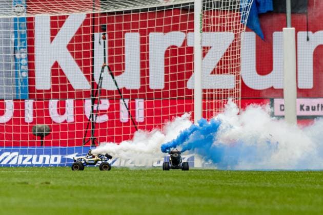 Rostock, Germany 17 February 2024 2 BL 2023 2024 FC Hansa Rostock vs Hamburger SV In the picture two remote-controlled cars with white and blue smoke on the pitch protest gegen investoren dfl DFL regulations prohibit any use of photographs as image sequences and or quasi video Copyright: xFotostandx xVoelkerx