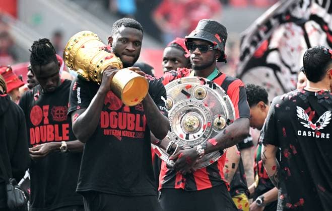 Football, , Germany, Men, Season 2023 2024, Coming Home, BayArena Leverkusen, Bayer Leverkusen celebrates the double Victor Boniface LEV and Edmond Tapsoba LEV with the championship trophy and the DFB Cup Cheers, joy, action DFB DFL REGULATIONS PROHIBIT ANY USE OF PHOTOGRAPHS AS IMAGE SEQUENCES AND OR QUASI VIDEO