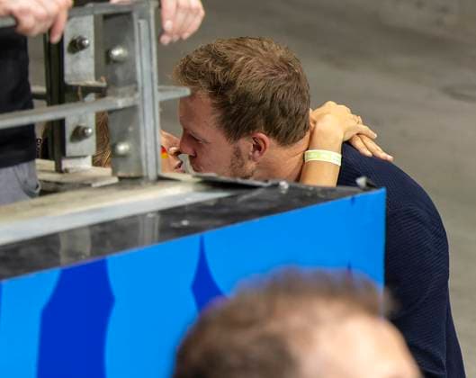 23 06 2024, Football UEFA EURO 2024, preliminary round, match day 3, Germany Switzerland, at the Frankfurt Arena in Frankfurt am Main, After the match, Lena Wurzenberger Germany the girlfriend of coach Julian Nagelsmann Germany wants to spend the moment alone with boyfriend Julian and hides from the photographers behind a wall in the interior for the winners kiss