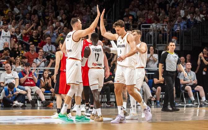 19 07 2024, Basketball, Men, International match, Friendly match, Germany Japan Johannes Voigtmann Germany, left, front and Franz Wagner Germany, right, front clap Berlin Uber Arena Berlin Germany