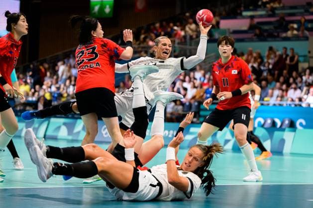 Paris, France Handball Women Preliminary Round Group A Germany Korea from left Bitna Woo Korea , Julia Behnke Germany , Xenia Smits Germany on the floor Paris South Paris Arena 6 France