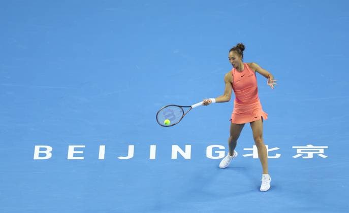 (241006) -- BEIJING, Oct. 6, 2024 -- Zheng Qinwen of China hits a return during the women s singles round of 16 match against Amanda Anisimova of the United States at the 2024 China Open tennis tournament in Beijing, capital of China, Oct. 2, 2024. ) Xinhua Headlines: Sports Golden Week boosts vitality in China DuxXinyi
