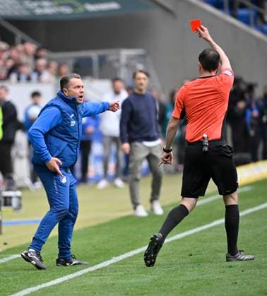Referee Referee Benjamin Brand shows TSG Hoffenheim caretaker red card red sending off for kicking perimeter advertising onto the pitch TSG 1899 Hoffenheim vs Borussia Dortmund BVB 26 04 2025 DFL REGULATIONS PROHIBIT ANY USE OF PHOTOGRAPHS AS IMAGE SEQUENCES AND OR QUASI VIDEO TSG 1899 Hoffenheim vs Borussia Dortmund BVB