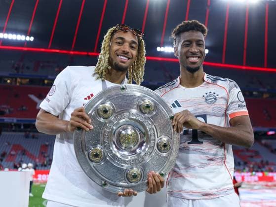 Soccer 1 Bundesliga 33 Matchday FC Bayern Munich Borussia Mönchengladbach on 10 05 2025 at the Allianz Arena in Munich Sascha Boey Munich , left Kingsley Coman Munich , right with the championship trophy DFL regulations prohibit any use of photographs as image sequences and or quasi video xMSx