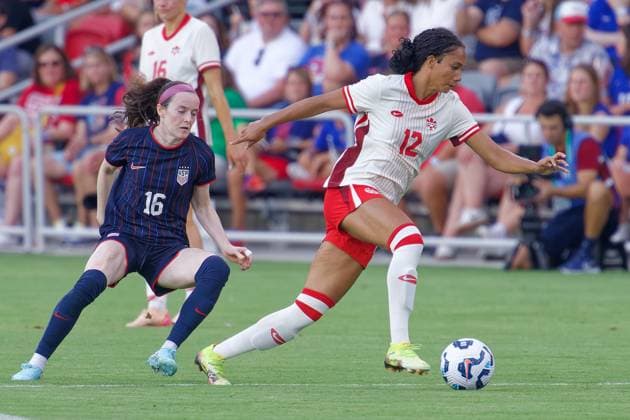 July 2, 2025, Washington, District of Columbia, USA: Jade Rose 12 of Canada drives past Rose Lavelle 16 of the United States during the US Woman™s national team, Nationalteam vs. Canada match at Audi Field. The USA won 3-0. Washington USA - ZUMA 20250702_mda_s363_177 Copyright: xJeffxScudderx