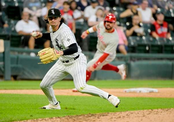 Chicago White Sox starting pitcher Davis Martin (65) making the throw to first for the out on Philadelphia Phillies Nick Castellanos (8) during the fifth inning at Rate Field in Chicago, IL on Monday, July 28, 2025.  CHI20250728116 MARKxBLACK