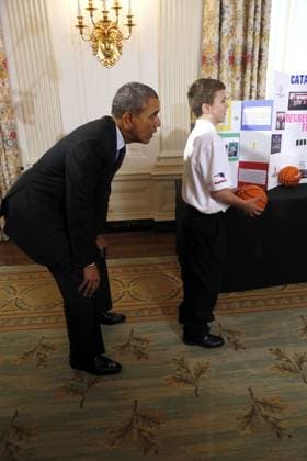 May 27, 2014 - Washington, District Of Columbia, U.S - United States President Barack Obama catches a ball from the Basketball Catapult a science project of Brooke Bohn (unseen), Daisjaughn Bass (unseen) and Gerry McManus (r), from Hudson Massachusetts, winners of the Raytheon and New England Patriots Science of Sports during the 2014 White House Science Fair at the White House, Washington DC, Tuesday May 27, 2014. The Fair celebrates the winners of STEM (science, technology, engineering and math) competitions across the country. Copyright: xAudexGuerrucci Pool Cnpx