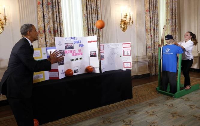 May 27, 2014 - Washington, District Of Columbia, U.S - United States President Barack Obama catches a ball from the Basketball Catapult a science project of Brooke Bohn (r), Daisjaughn Bass (unseen) and Gerry McManus (unseen), from Hudson Massachusetts, winners of the Raytheon and New England Patriots Science of Sports during the 2014 White House Science Fair at the White House, Washington DC, Tuesday May 27, 2014. The Fair celebrates the winners of STEM (science, technology, engineering and math) competitions across the country. Copyright: xAudexGuerrucci Pool Cnpx