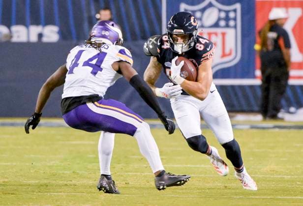 Chicago Bears tight end Colston Loveland (84) looks to move around Minnesota Vikings safety Joshua Metellus (44) during the third quarter at Soldier Field in Chicago on Monday, September 8, 2025. The Vikings defeated the Bears 27-24. CHI20250908117 MARKxBLACK